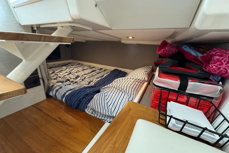 Slide: The Image of 2023 Tiara Yachts 43 LS cabin interior with bed and storage area. - 73