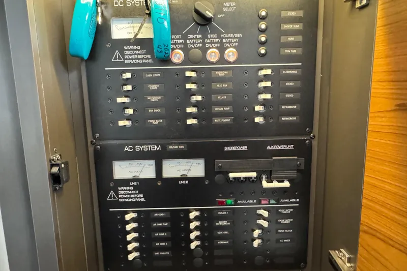 Slide: The Image of Electrical control panel on 2023 Tiara Yachts 43 LS, featuring DC and AC systems. - 79