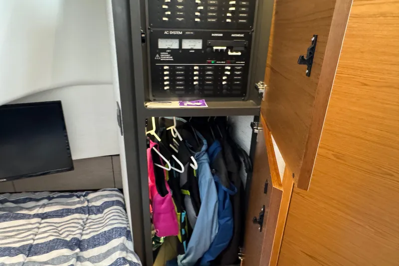 Slide: The Image of 2023 Tiara Yachts 43 LS interior with control panel and closet space. - 80