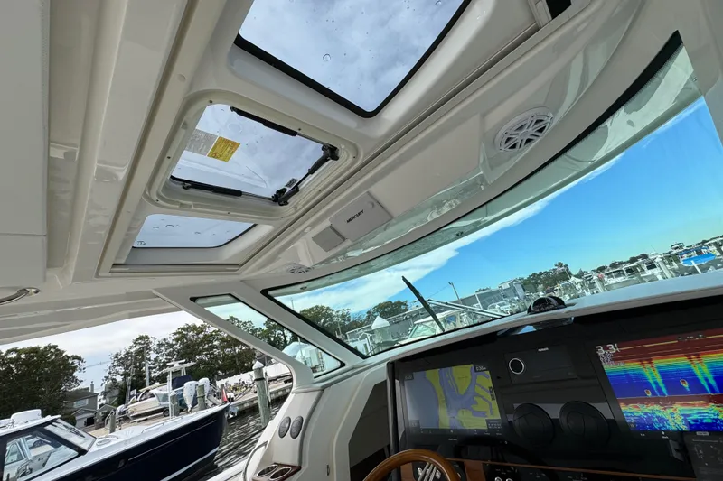 Slide: The Image of Interior view of 2023 Tiara Yachts 43 LS, showcasing navigation equipment and sunroof. - 90