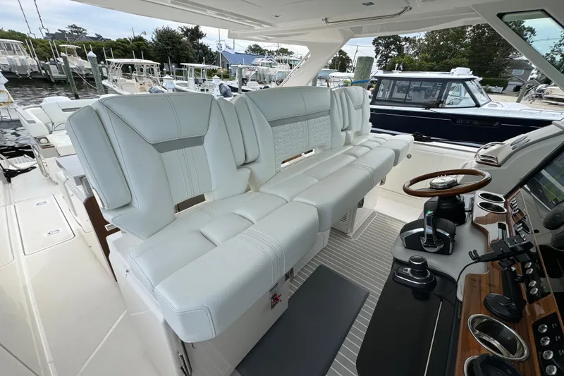 Slide: The Image of Luxurious interior of 2023 Tiara Yachts 43 LS with plush white seating and modern controls. - 91