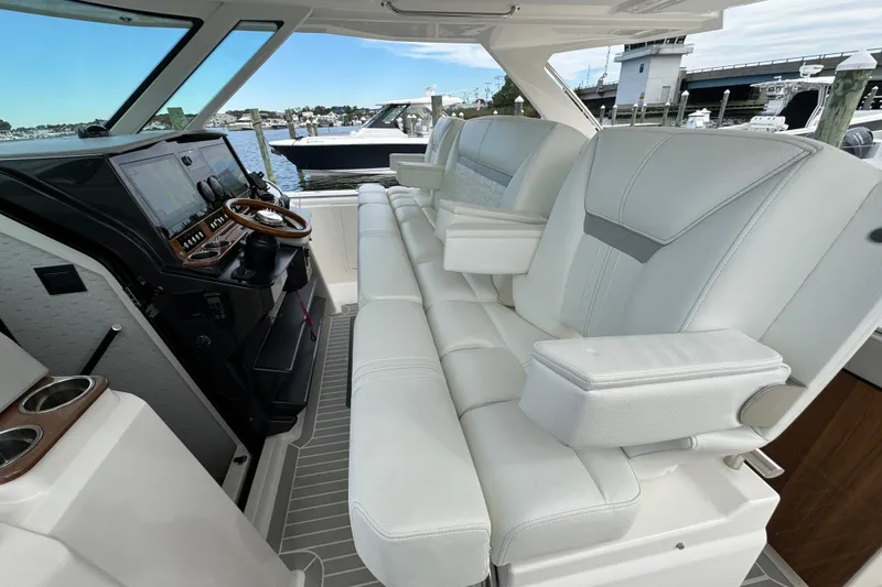 Slide: The Image of 2023 Tiara Yachts 43 LS interior with luxurious seating and modern helm controls. - 92