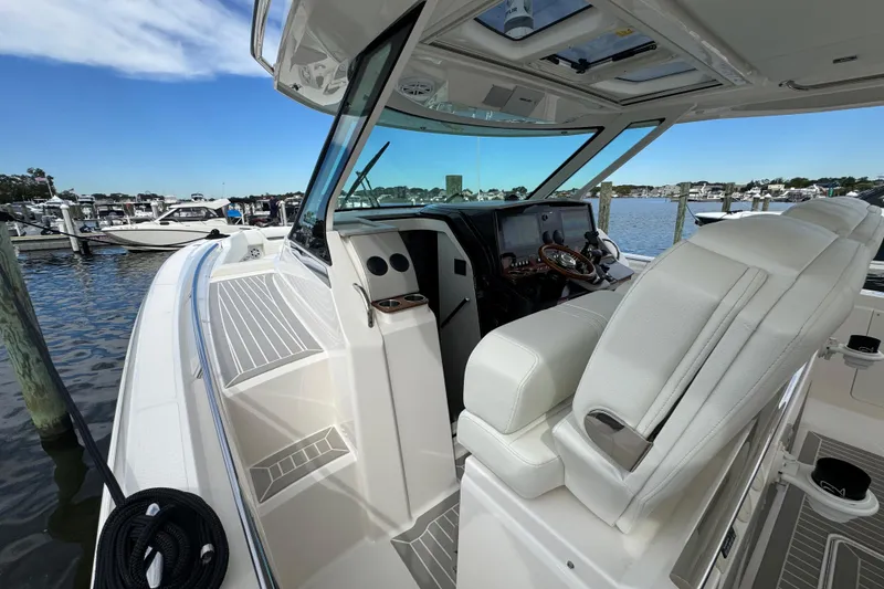 Slide: The Image of 2023 Tiara Yachts 43 LS cockpit with luxurious seating and advanced navigation system. - 95