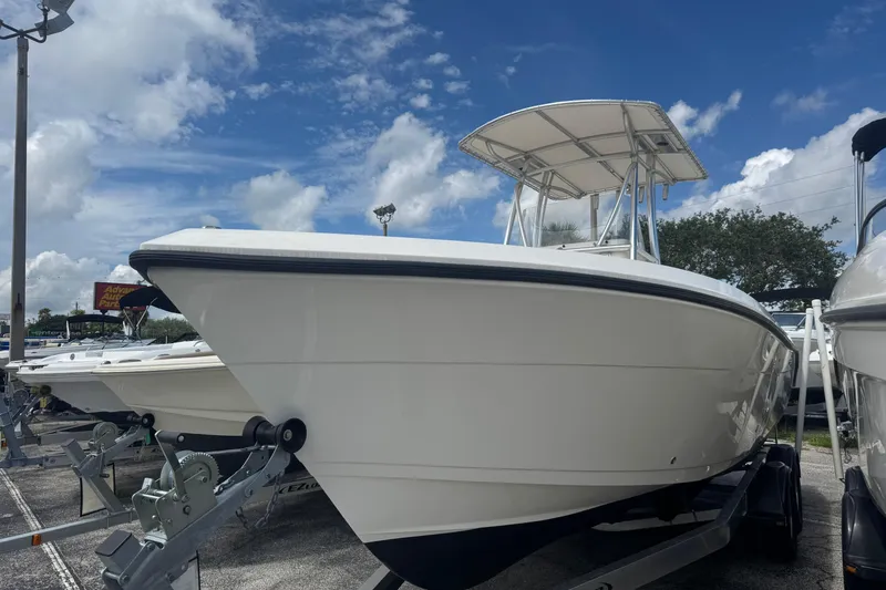 Slide: The Image of 2022 Cobia 237 Center Console boat on trailer under blue sky. - 2