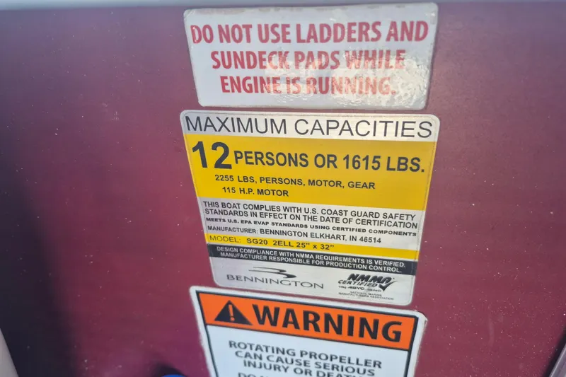 Slide: The Image of 2012 Bennington 22 SSI capacity label: 12 persons or 1615 lbs, safety warnings included. - 12