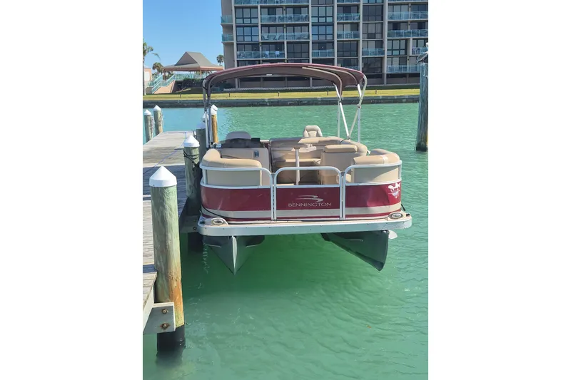 Slide: The Image of 2012 Bennington 22 SSI pontoon boat docked in clear turquoise water. - 16