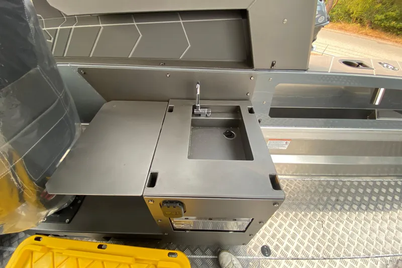 Slide: The Image of Interior of 2026 Stabicraft 2350 Supercab featuring a compact sink and storage area. - 4