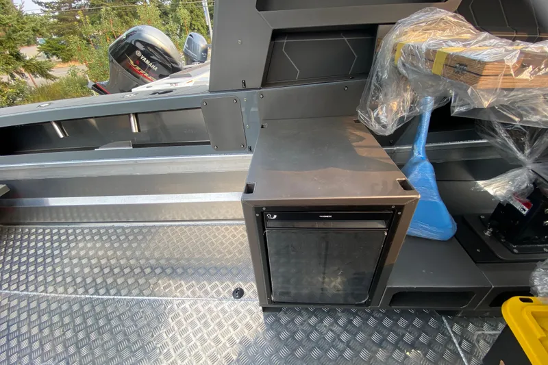 Slide: The Image of 2026 Stabicraft 2350 Supercab interior with storage and Yamaha engine visible. - 5