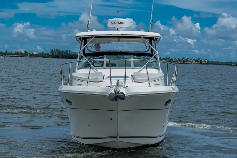 Slide: The Image of 2002 Sport-Craft 3150 Sportfish boat on water under blue sky. - 1