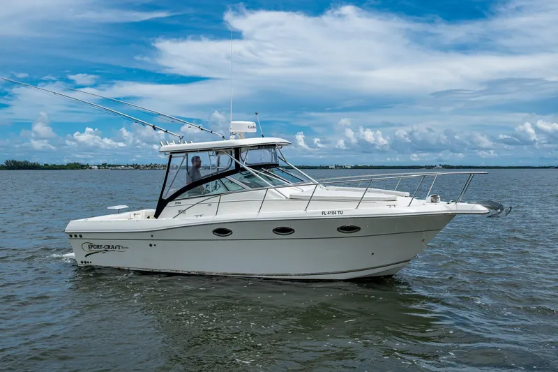 Slide: The Image of 2002 Sport-Craft 3150 Sportfish boat on calm water under a blue sky. - 10