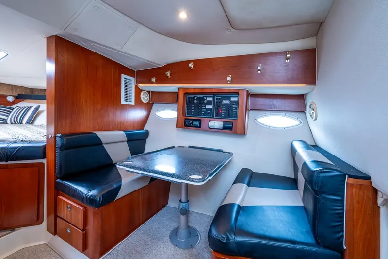 Slide: The Image of 2002 Sport-Craft 3150 Sportfish cabin interior with dining area and control panel. - 11