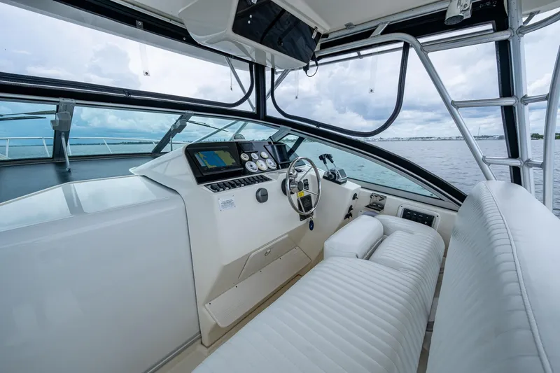 Slide: The Image of 2002 Sport-Craft 3150 Sportfish boat interior with steering wheel and navigation equipment. - 24