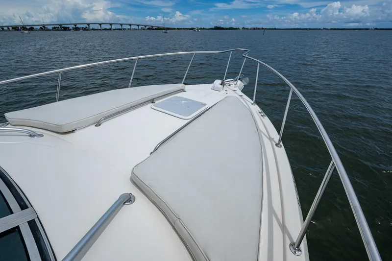 Slide: The Image of 2002 Sport-Craft 3150 Sportfish boat deck with railing, overlooking calm waters and distant bridge. - 31