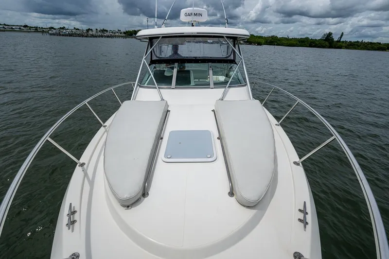 Slide: The Image of 2002 Sport-Craft 3150 Sportfish boat on water, cloudy sky background. - 33