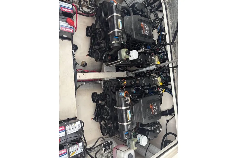 Slide: The Image of Engine compartment of a 2002 Sport-Craft 3150 Sportfish boat, featuring dual engines. - 35