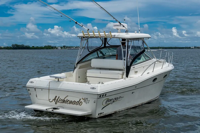 Slide: The Image of 2002 Sport-Craft 3150 Sportfish boat cruising on a calm, scenic waterway. - 7