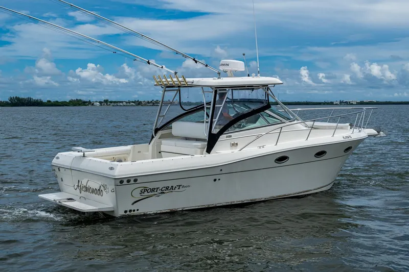 Slide: The Image of 2002 Sport-Craft 3150 Sportfish boat cruising on open water under a clear sky. - 8
