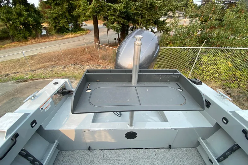 Slide: The Image of 2026 Hewescraft 180 Sportsman boat with a mounted cutting board and outboard motor. - 8