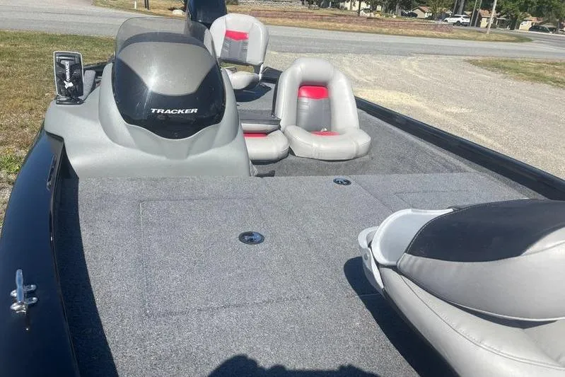 Slide: The Image of 2017 Tracker Pro Team 175 TXW fishing boat interior with seating and console. - 3