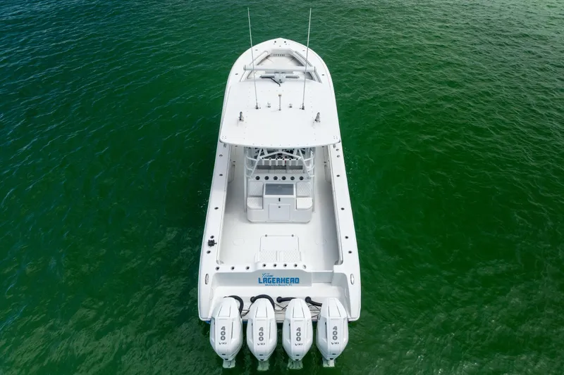 Slide: The Image of 2009 Yellowfin 42 Offshore boat with four engines on green water. - 10