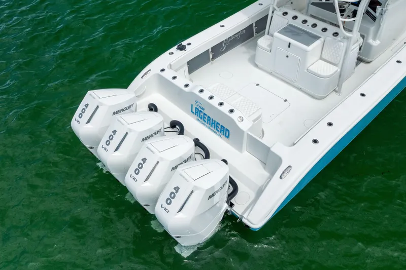 Slide: The Image of 2009 Yellowfin 42 Offshore boat with four Mercury 400 V10 engines on green water. - 12