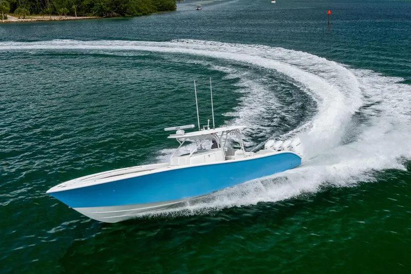 Slide: The Image of 2009 Yellowfin 42 Offshore boat making a sharp turn on open water. - 17