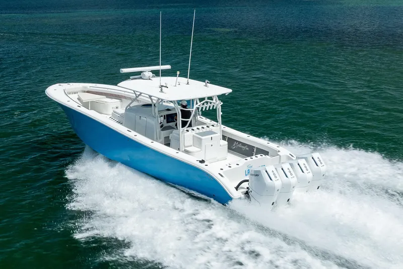 Slide: The Image of 2009 Yellowfin 42 Offshore boat cruising on open water, showcasing powerful engines. - 18