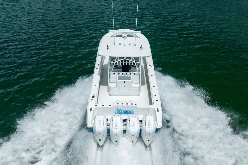Slide: The Image of 2009 Yellowfin 42 Offshore boat cruising on open water, rear view. - 19