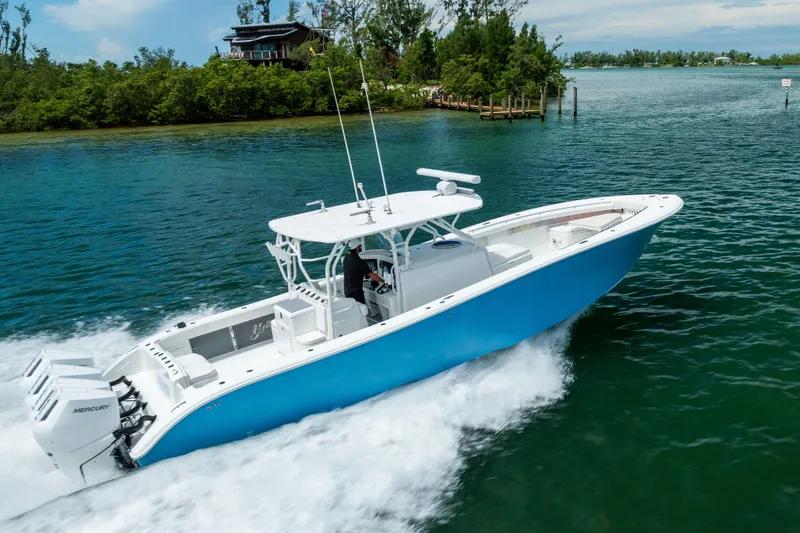Slide: The Image of 2009 Yellowfin 42 Offshore boat cruising on clear blue water. - 22
