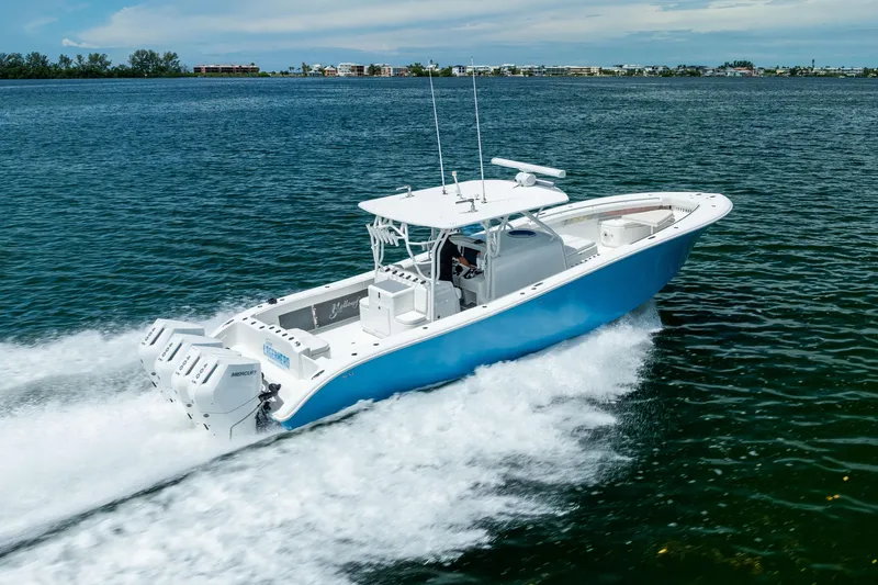 Slide: The Image of 2009 Yellowfin 42 Offshore boat cruising on open water, showcasing powerful engines. - 25