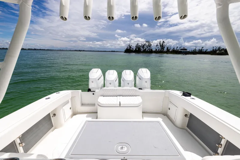 Slide: The Image of 2009 Yellowfin 42 Offshore boat with quad engines on calm water under a cloudy sky. - 26