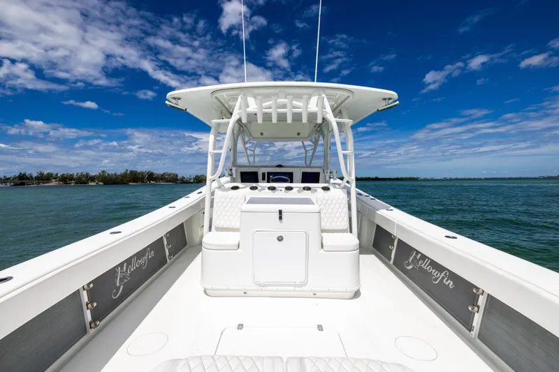 Slide: The Image of 2009 Yellowfin 42 Offshore boat on open water under a clear blue sky. - 30