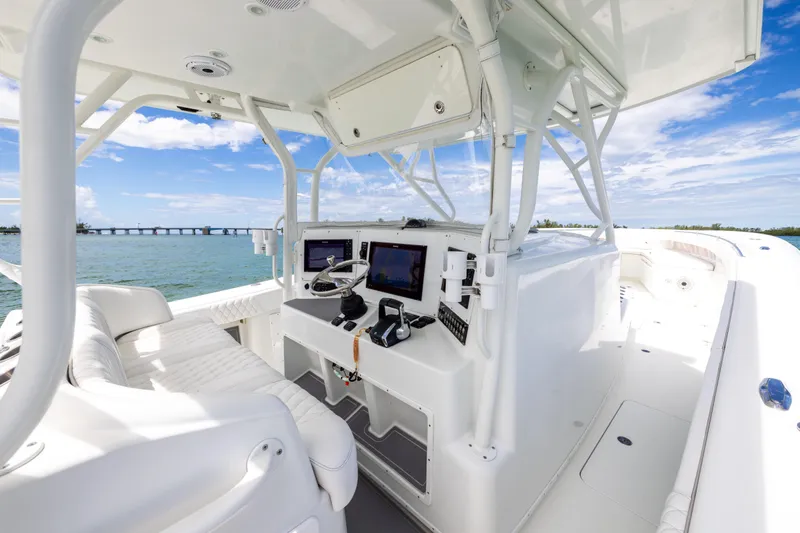 Slide: The Image of 2009 Yellowfin 42 Offshore boat interior with modern navigation equipment and ocean view. - 34