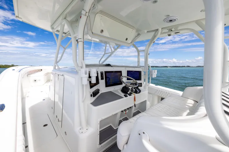 Slide: The Image of 2009 Yellowfin 42 Offshore boat cockpit with modern navigation equipment, cruising on open water. - 36