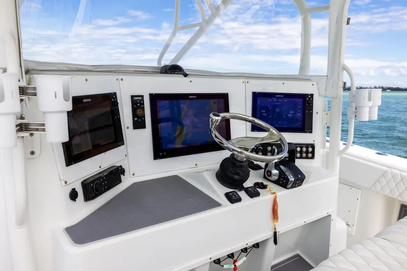 Slide: The Image of Helm of 2009 Yellowfin 42 Offshore boat with advanced navigation systems. - 37