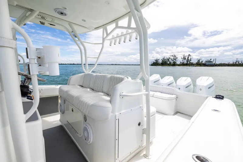 Slide: The Image of 2009 Yellowfin 42 Offshore boat with white seating and multiple outboard engines on a sunny day. - 39