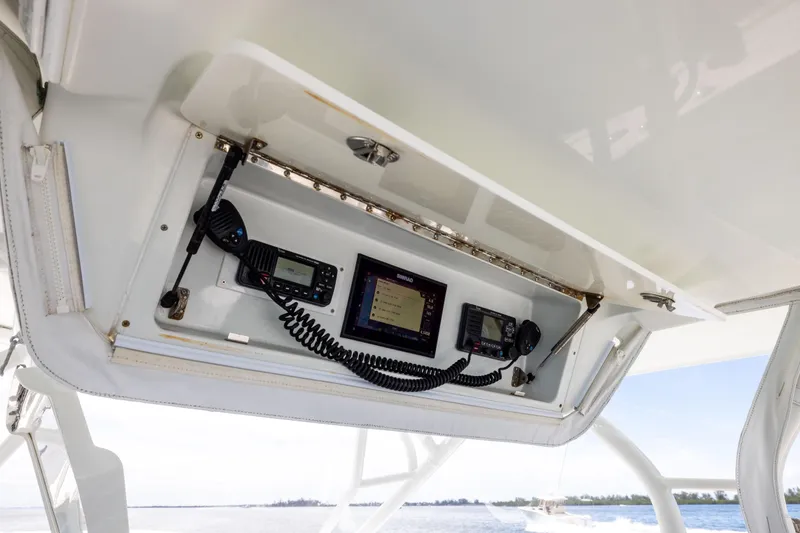 Slide: The Image of 2009 Yellowfin 42 Offshore boat electronics panel with communication devices and navigation screens. - 40
