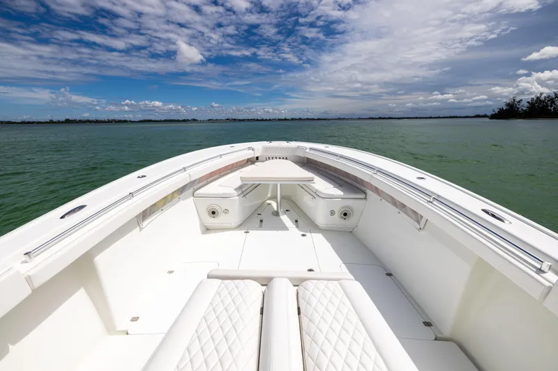Slide: The Image of 2009 Yellowfin 42 Offshore boat on calm water under a partly cloudy sky. - 41