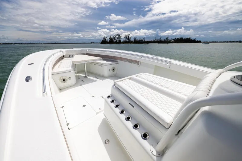 Slide: The Image of 2009 Yellowfin 42 Offshore boat interior with white seating and ocean view. - 42