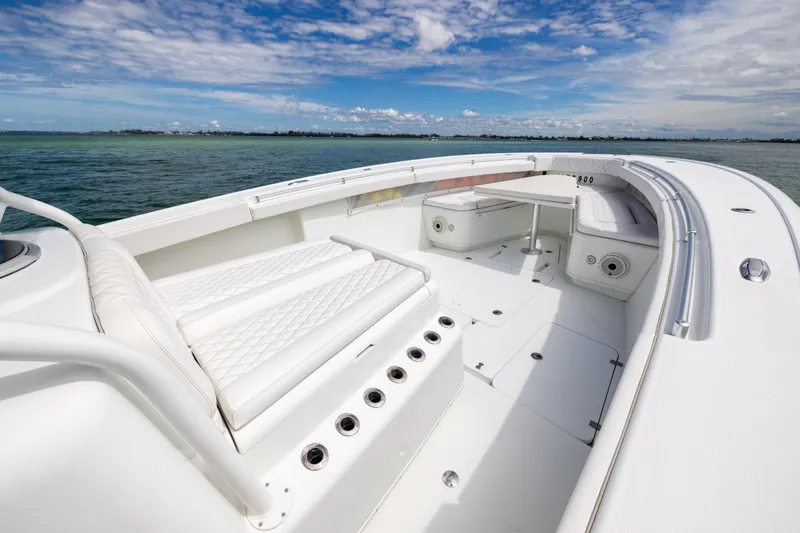 Slide: The Image of 2009 Yellowfin 42 Offshore boat interior with white seating, ocean view, and blue sky. - 43