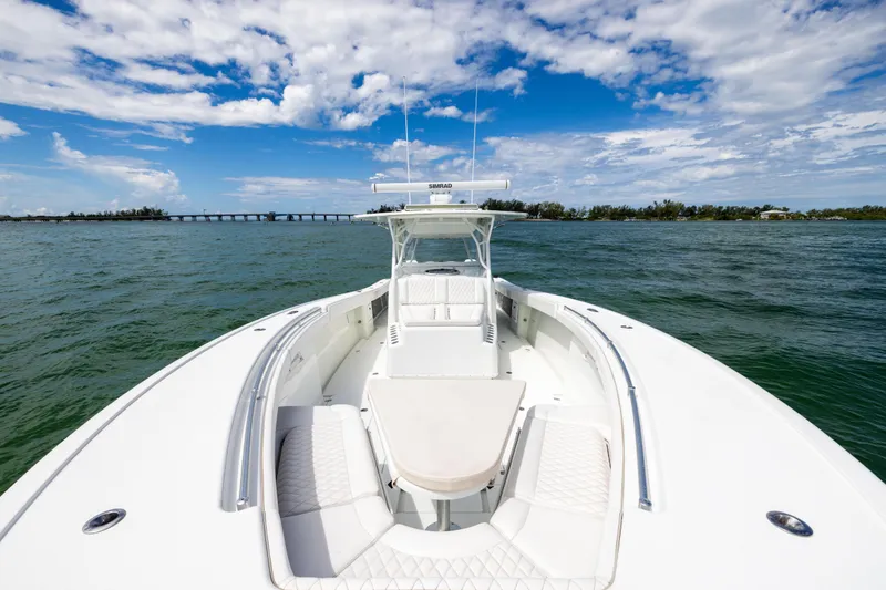 Slide: The Image of 2009 Yellowfin 42 Offshore boat on open water under a partly cloudy sky. - 44