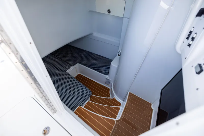 Slide: The Image of 2009 Yellowfin 42 Offshore cabin interior with wooden flooring and cushioned seating. - 49