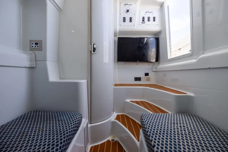 Slide: The Image of Interior of 2009 Yellowfin 42 Offshore boat with seating, wood flooring, and control panels. - 50