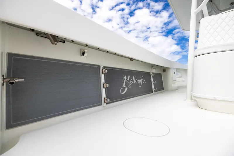 Slide: The Image of 2009 Yellowfin 42 Offshore boat deck with logo, under a partly cloudy sky. - 53
