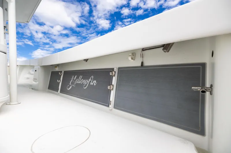 Slide: The Image of 2009 Yellowfin 42 Offshore boat deck with logo, under a blue sky. - 54
