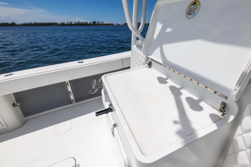 Slide: The Image of 2009 Yellowfin 42 Offshore boat interior with open storage compartment by the water. - 56