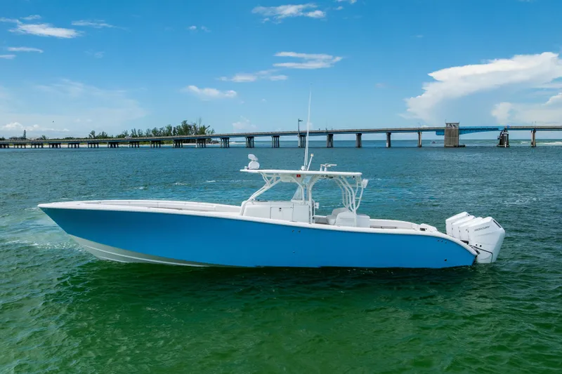 Slide: The Image of 2009 Yellowfin 42 Offshore boat on water, with bridge in background. - 7