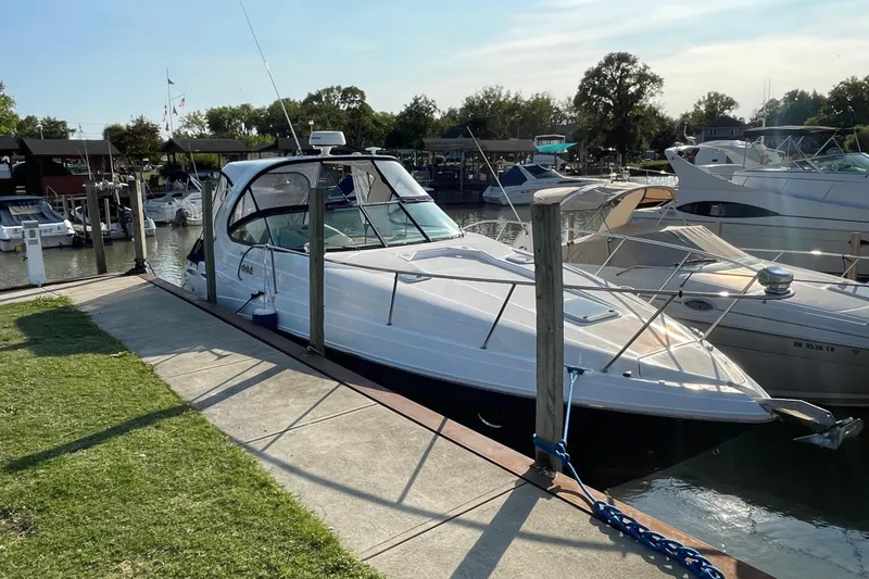 Slide: The Image of 2019 Rinker 370 EX yacht docked at a marina on a sunny day. - 1