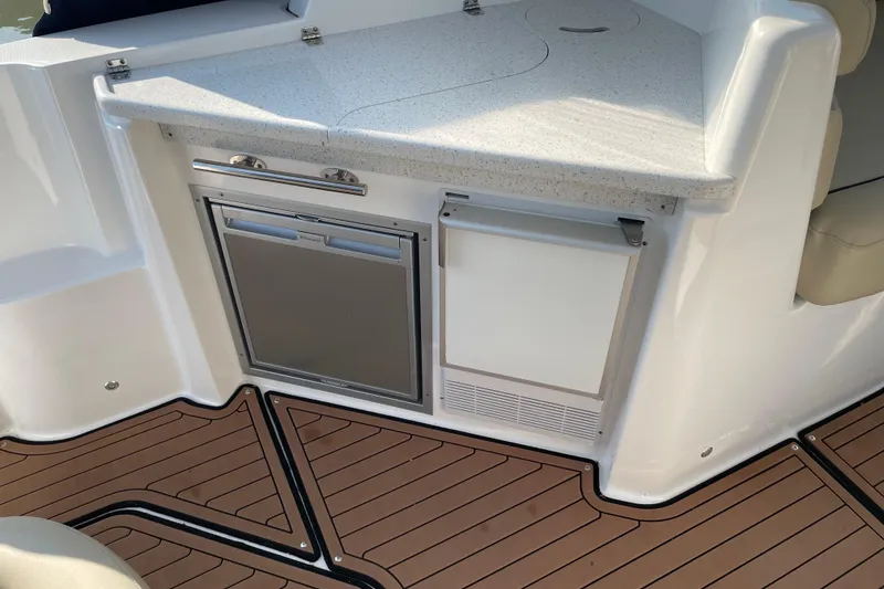 Slide: The Image of 2019 Rinker 370 EX boat dashboard with steering wheel and control panel. - 14