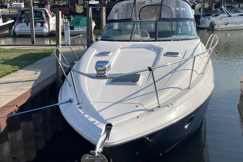 Slide: The Image of 2019 Rinker 370 EX boat docked in a marina, front view. - 2
